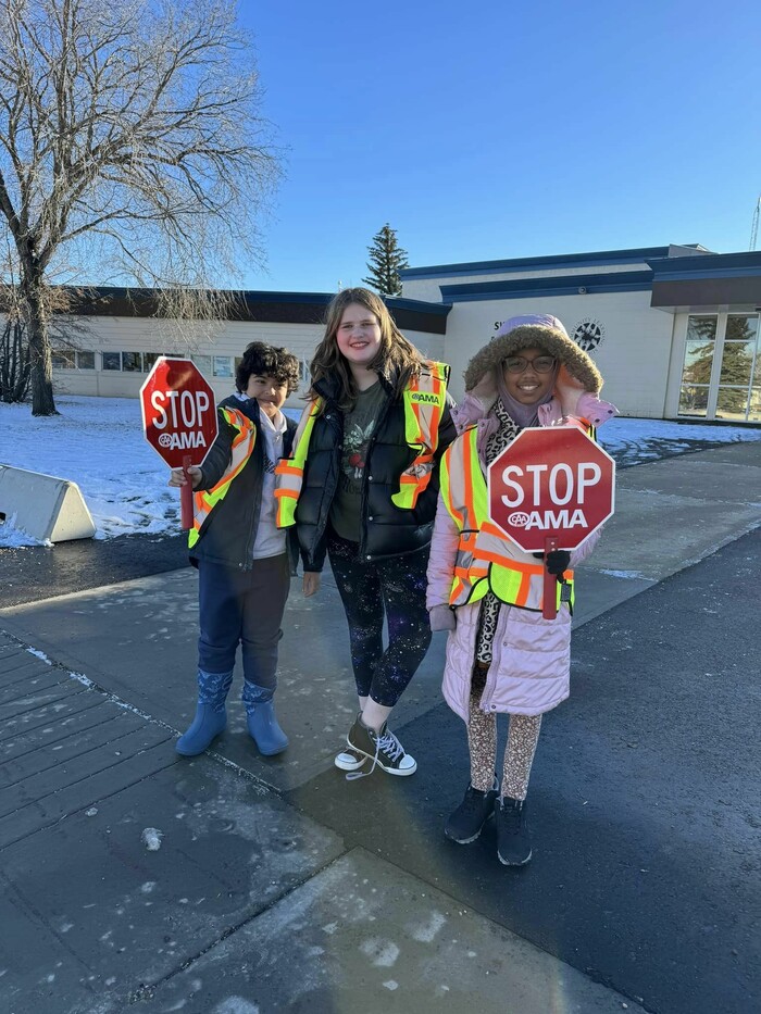 students standing outside in winter with stop signs