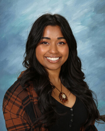 Headshot of Raynne smiling at camera